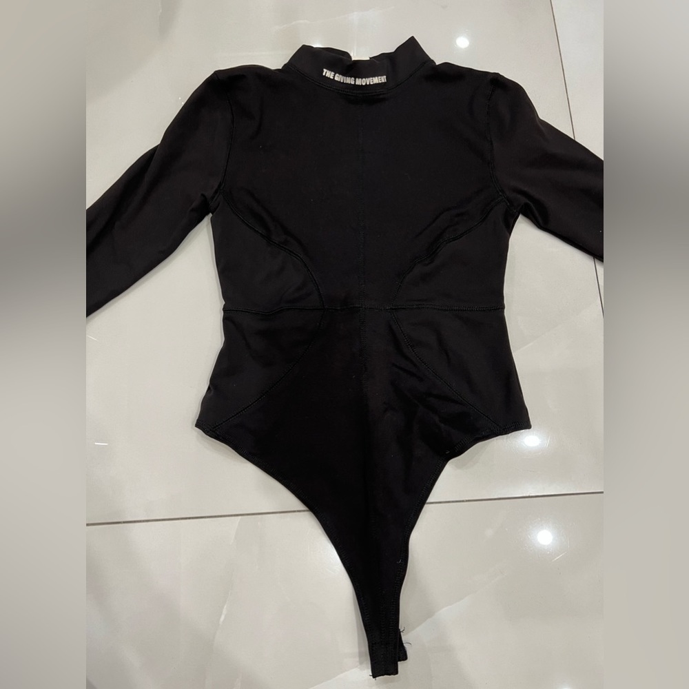 The Giving Movement black bodysuit.
